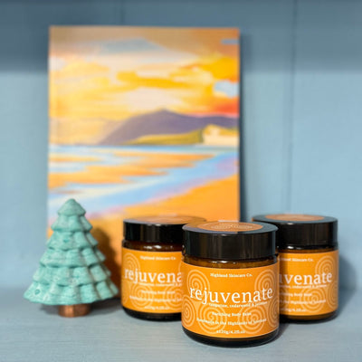Three jars labeled 'rejuvenate' with a decorative tree and abstract painting in the background.